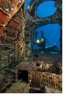 Andrea scuba diving exploring a Japanese Zero