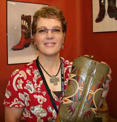 Lisa Sorrell holds a pair of her custom made boots