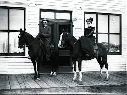 Woman sitting sidesaddle on a horse
